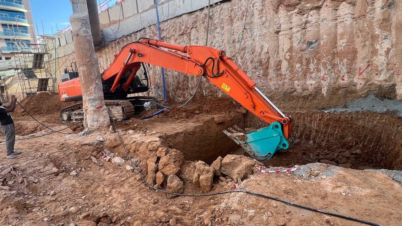 MACO Hitachi excavator on a deep urban excavation site in central Dubai